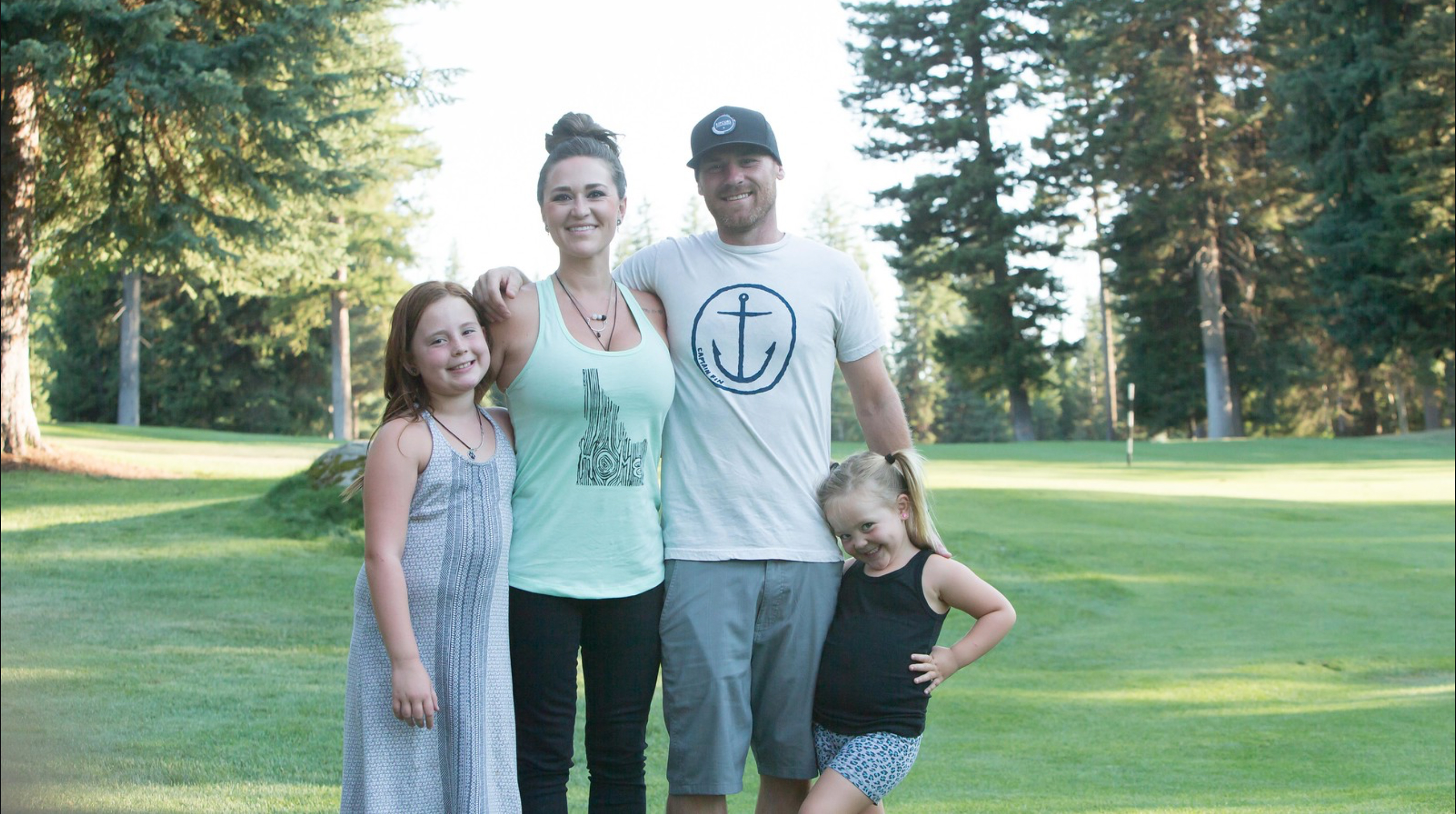 a smiling family in an outdoor setting