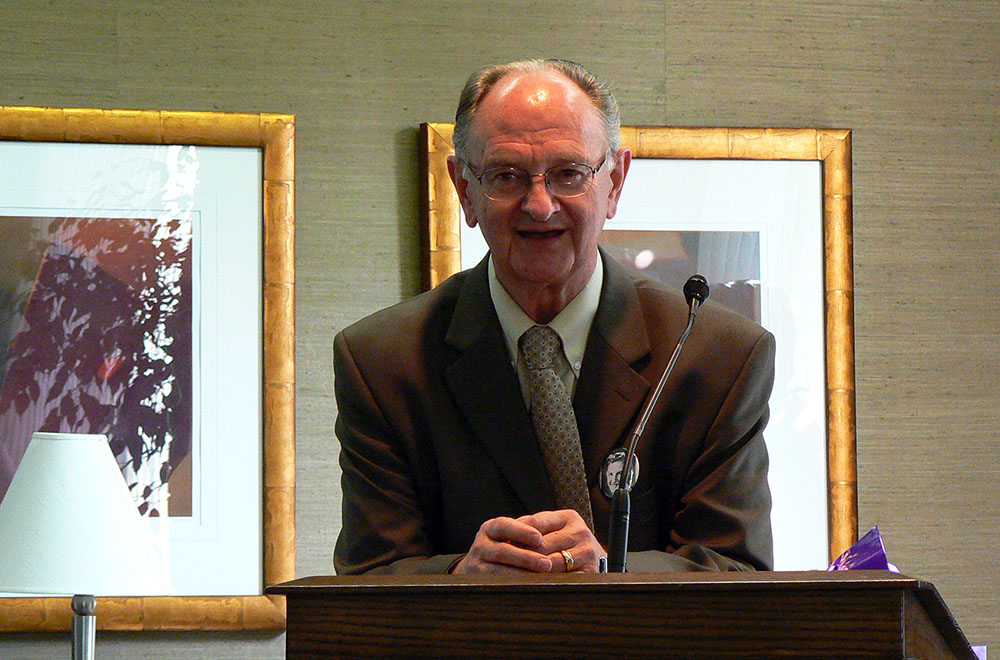 Dr. Fred Janzen speaking at a podium
