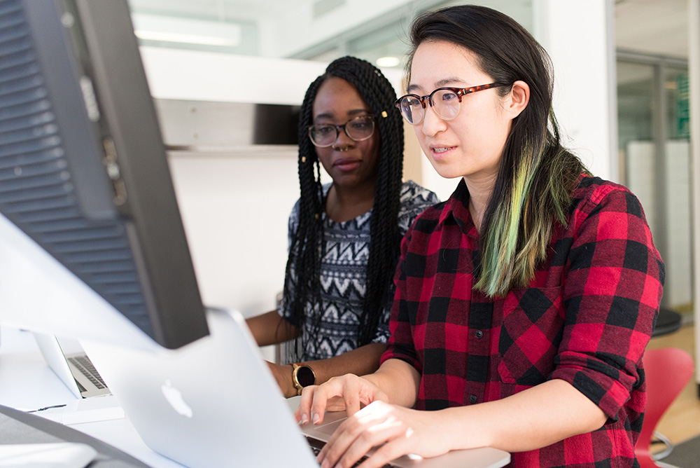 Two women working in front of a computer