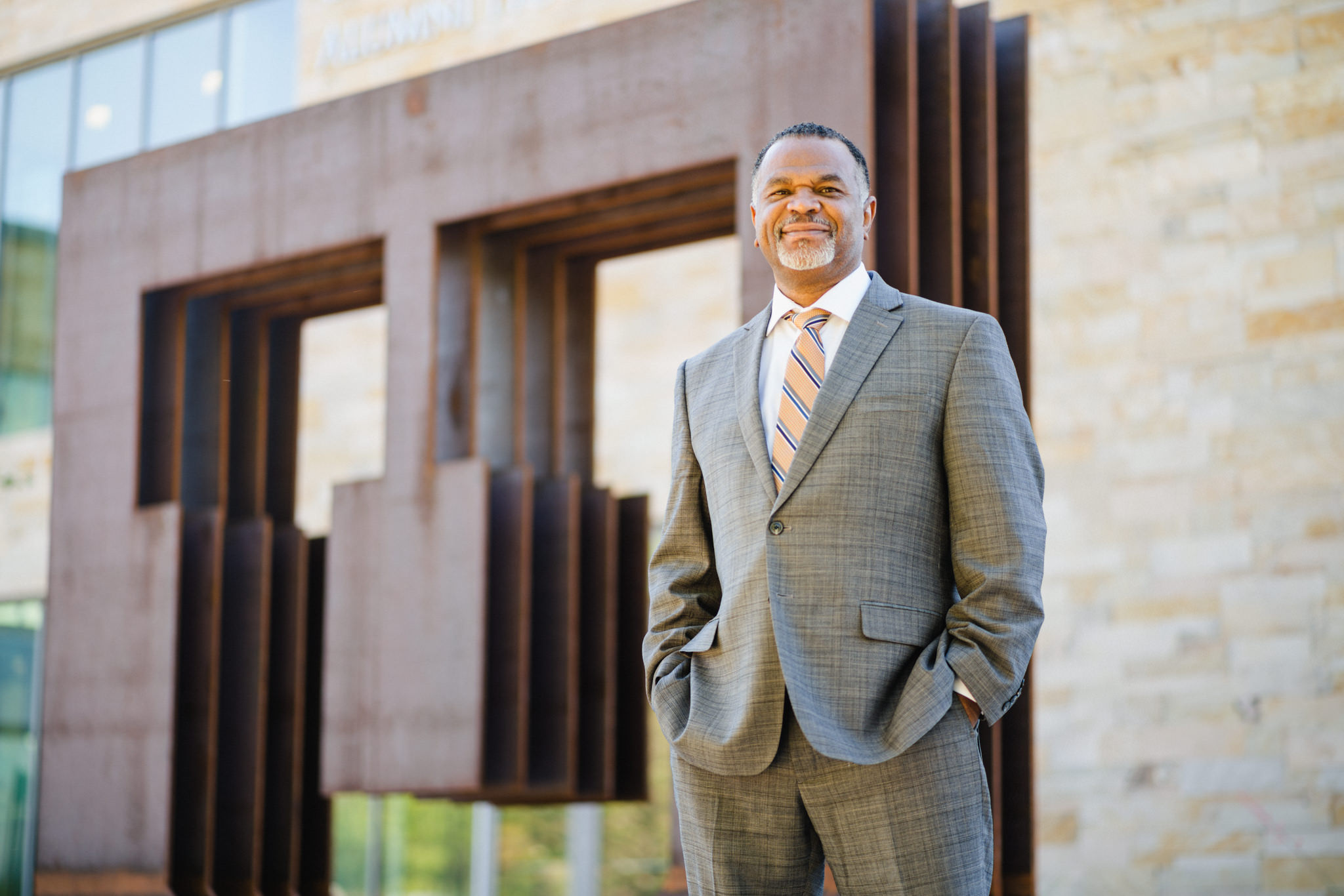 a photo of Dean Martell Teasley standing in front of an outdoor sculpture