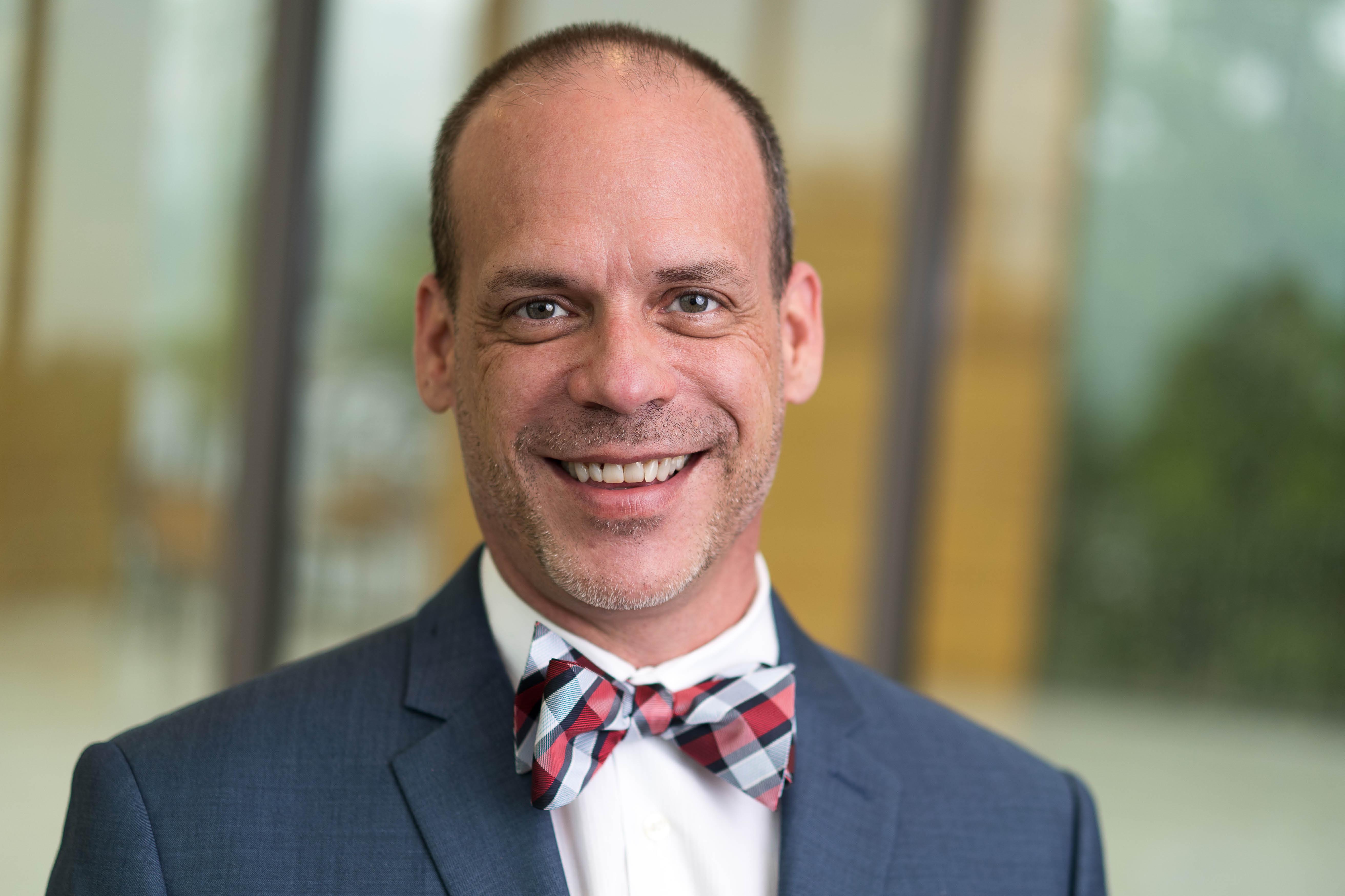 A headshot of the interim dean, Philip Osteen, looking at the camera and smiling