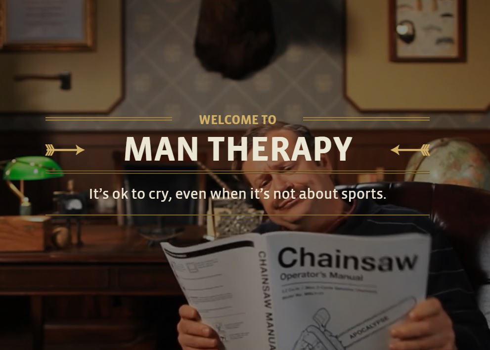 A screenshot of a website. A middle aged moustachioed white man reads a chainsaw manual with the words "Welcome to Man Therapy: It's ok to cry, even when it's not about sports" superimposed over the image.