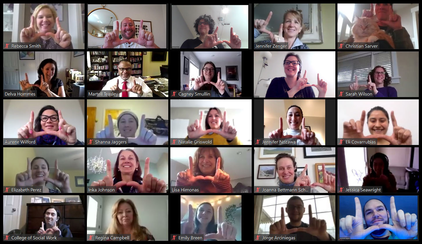 A screen shot of the a video conference with College of Social Work's staff council, with everyone flashing a U